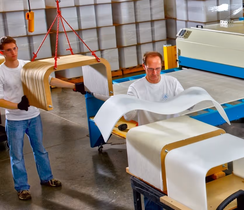 Workers drape forming custom acrylic retail displays