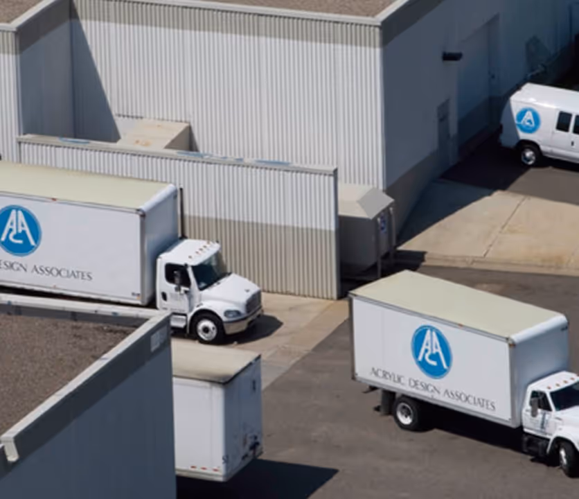 Trucks in a loading dock, hauling recycled acrylic