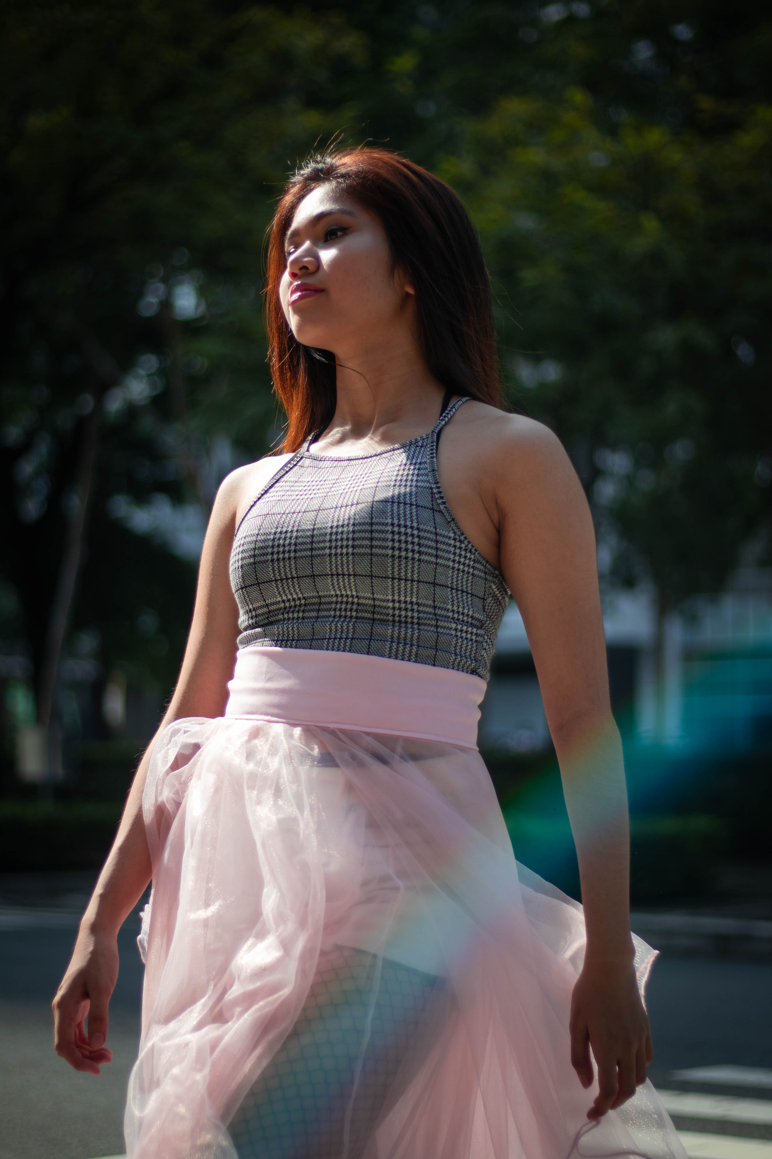 Portrait of a girl walking down the crosswalk in a pink tulle skirt