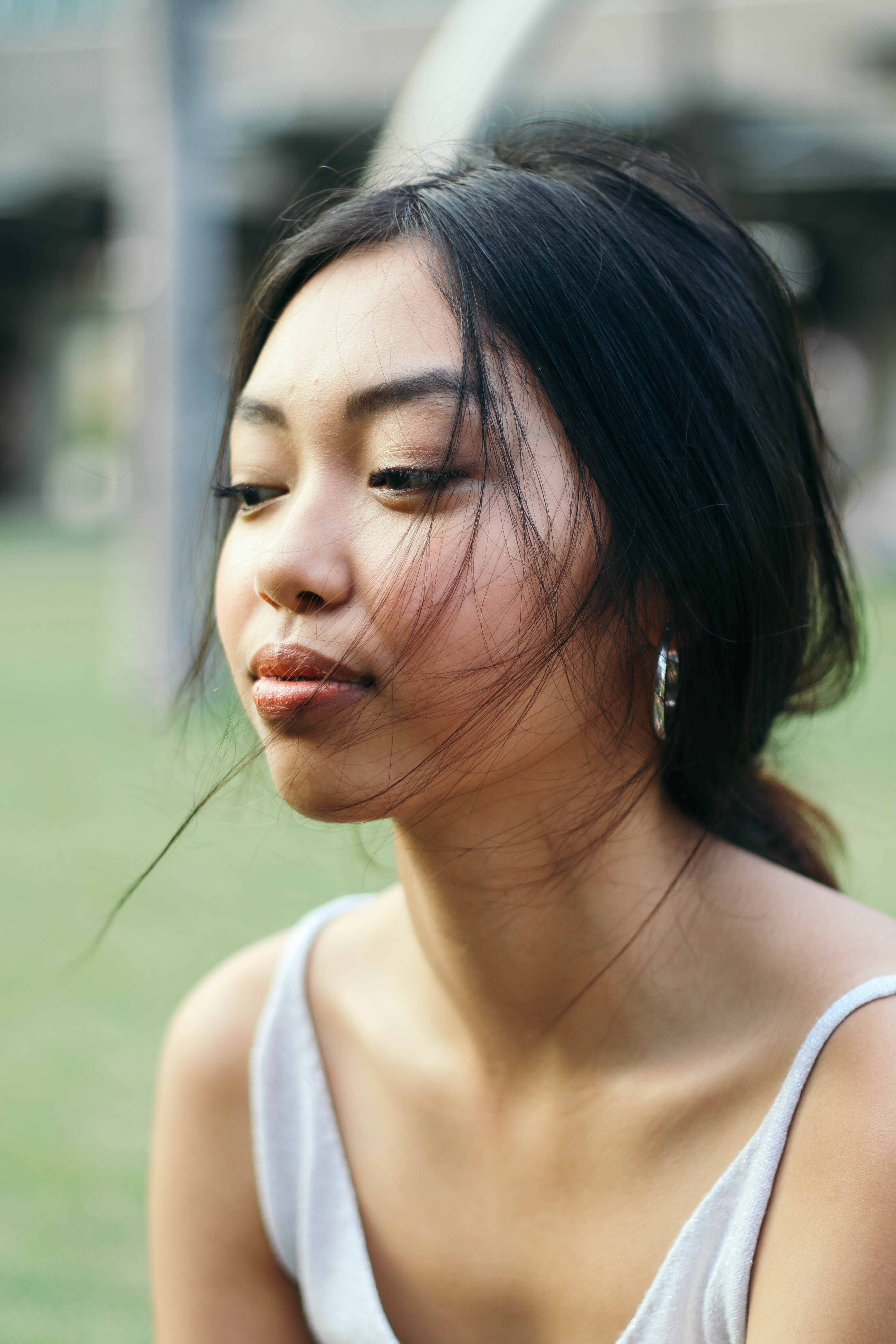 Portrait of a girl looking away from camera, hair tied in a ponytail