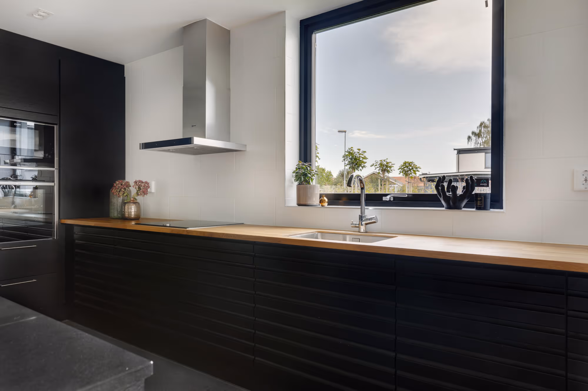 a kitchen with a large window and a sink