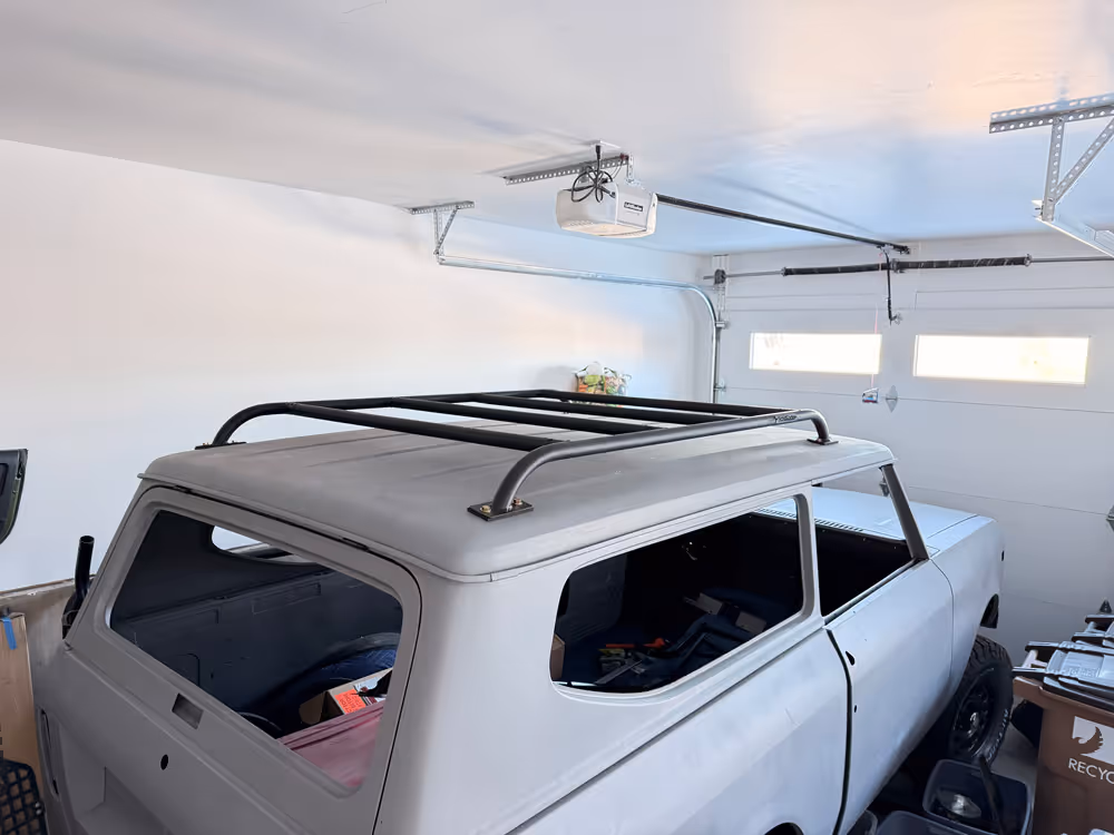 Rusty blue and white vintage off-road Scout II with a Scout Racks Roof Rack installed.