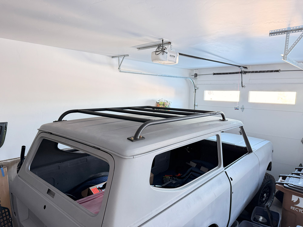 Rusty blue and white vintage off-road Scout II with a Scout Racks Roof Rack installed.