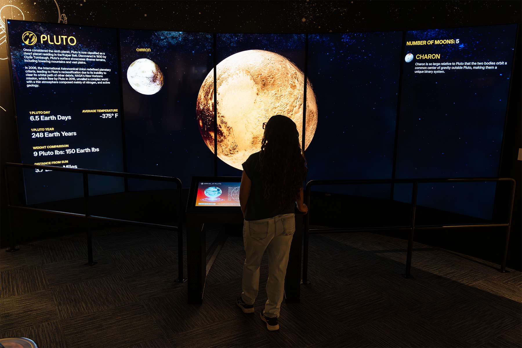 Visitors select a planet via a Reader Rail kiosk, then are immersed in a sweeping visual journey across the solar system guided by Clyde Tombaugh’s voice.