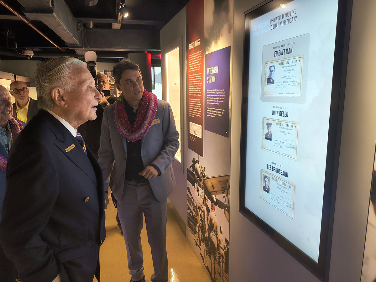 USS Missouri veteran Mr. Ed Buffman and Curator Frank Clay take a look at the interactive interview station that is part of Pathway to Peace.