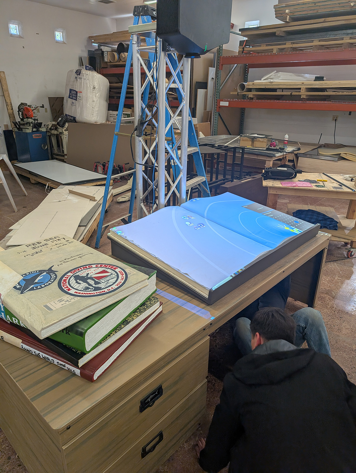 Integration and testing of the Enchanted Book and desk in Ideum’s fabrication studio.