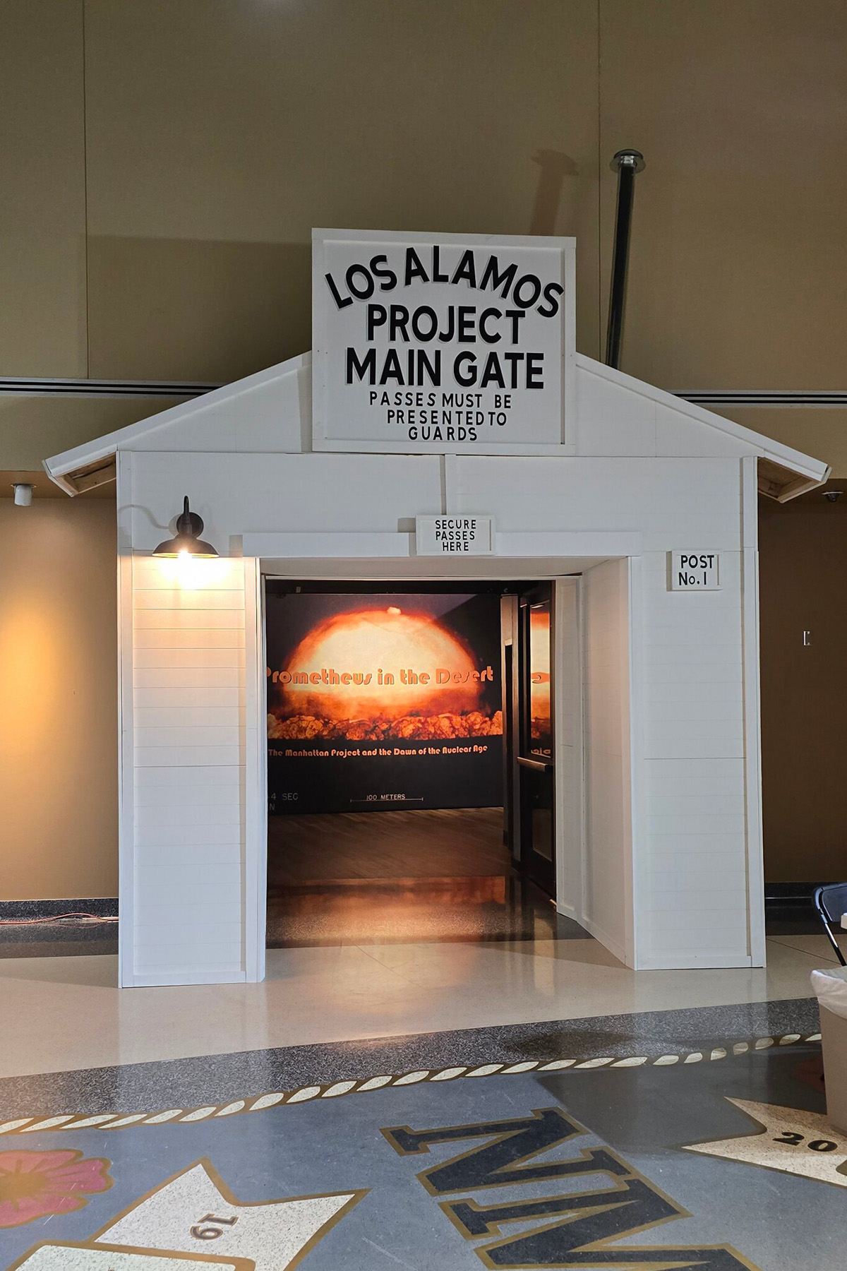 To enter the exhibit, visitors first cross through a replica of Los Alamos' East Main Gate.