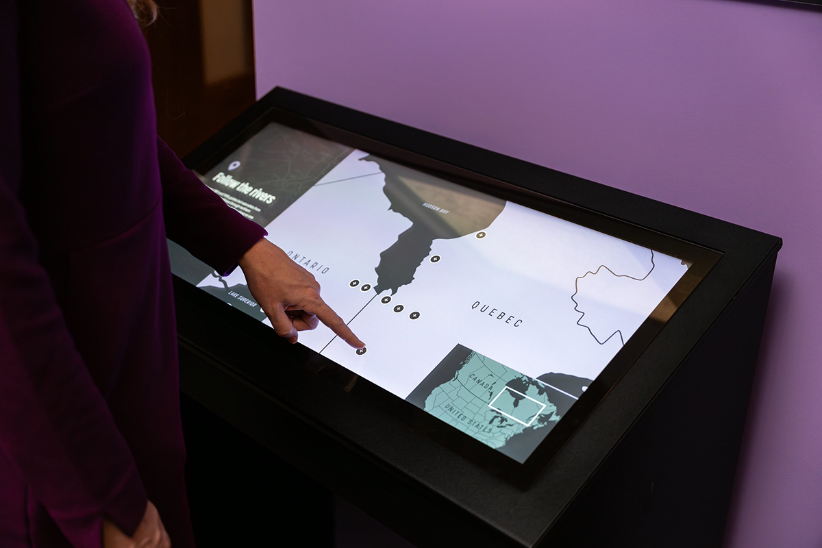 Carnegie Museum of Natural History uses a map of Northern Ontario and Quebec as their hero image to organize touchpoints that open up media viewers sharing historic photographs of expeditions in the region.