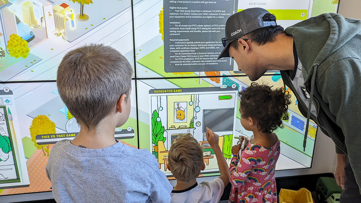 At the Chelan County Experience Wall, families play an interactive game to discover how everyday choices conserve energy and water; above, adult guests explore energy options that affect their real-world bills.