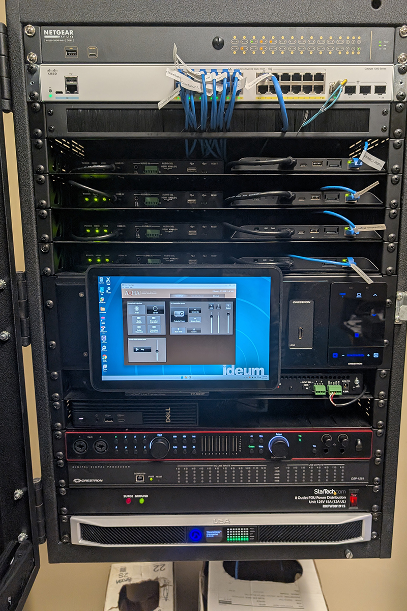 The custom A/V installation is controlled from a server rack, and includes infrastructure that would allow the addition of more projectors in the future.