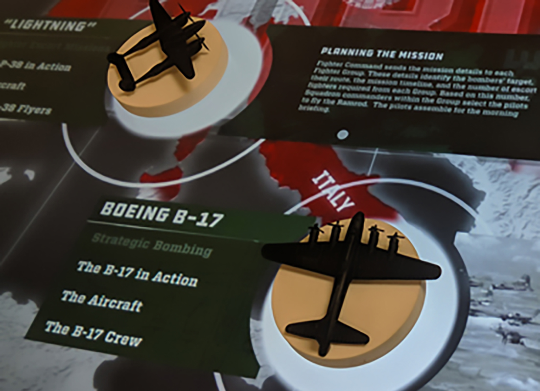 These tangibles are affixed with 3D prints of iconic WWII-era planes, and the application was built using the Tangible Engine Media Creator. 