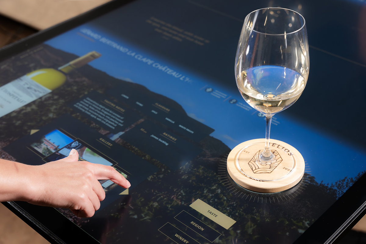 The Helios Wine Bar was the first instance of our Beverage tangibles, and featured a conductive coaster that when placed on the table, provided detailed information about the wine in a guest’s glass.