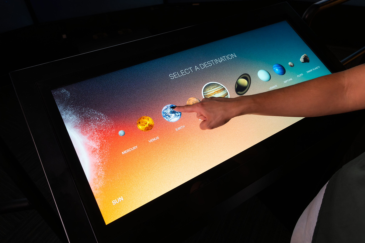 A 34” Reader Rail touch kiosk acts as the controller where users can select their celestial destination.