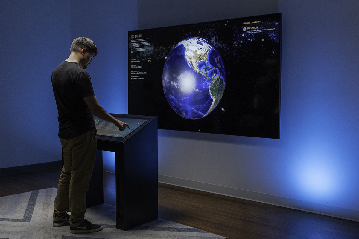 The exhibit can be configured for a range of spaces, such as this version utilizing a large wall-mounted display.