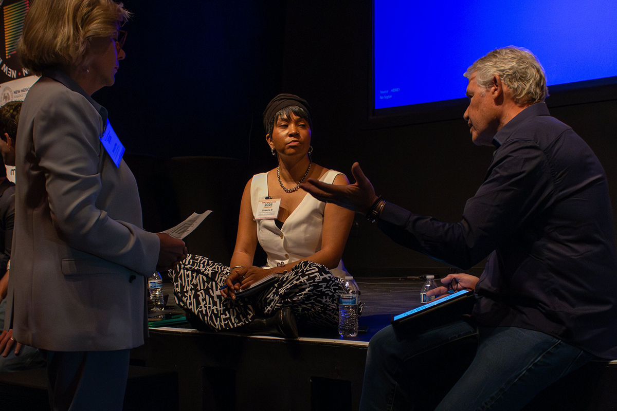 Prior to taking the stage, panel moderator Nancy Bos speaks with panelists Shawna Brown, Director of ABQ MainStreet, and Jim Spadaccini, Ideum’s CEO.