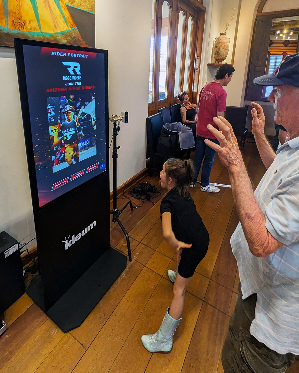 Event attendees playing with the Join the Team exhibit, stepping into the shoes of professional bull riders for an afternoon.