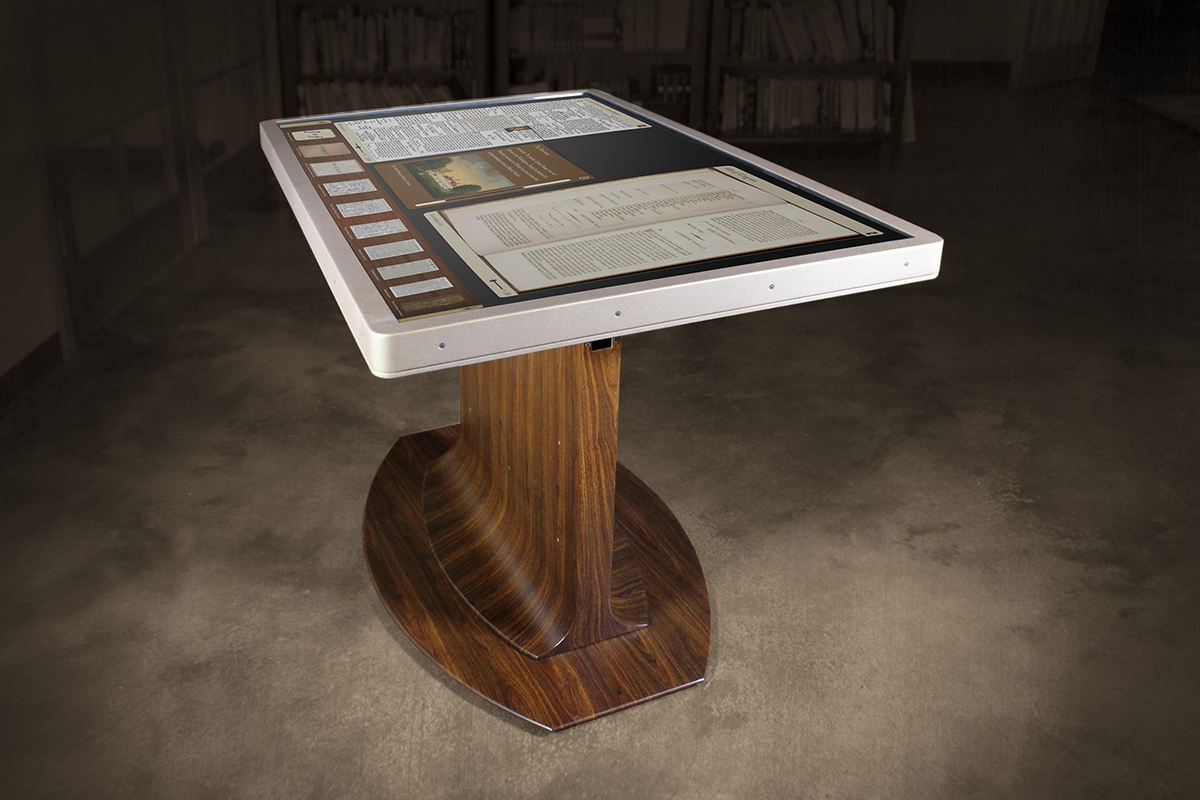 A powder-coated brass finish was applied to the 55” display frame along with a hydro-dipped faux wood grain application to the base for Mount Vernon’s library. 