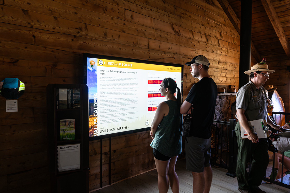 An 86” Presenter is mounted to the wall for users to explore park maps and access a live seismograph feed at Valles Caldera National Preserve.