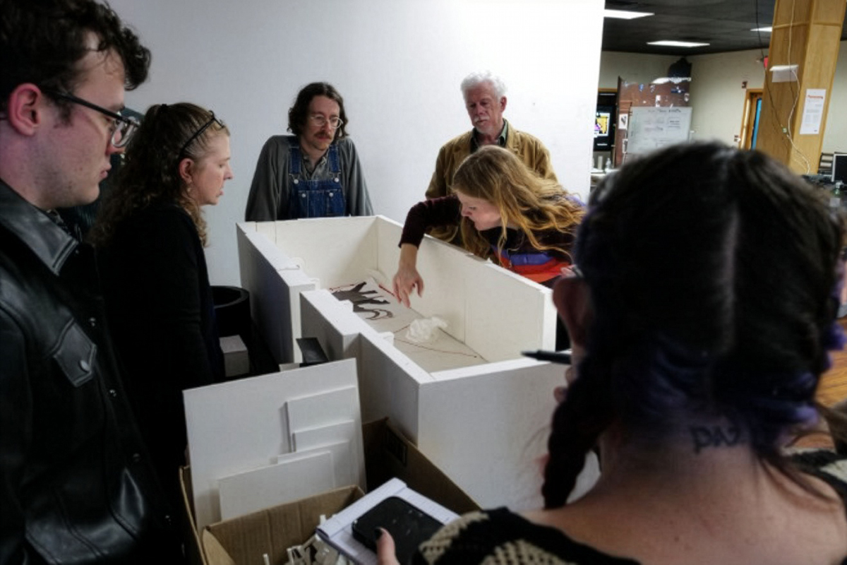 San Mateo County History Museum Deputy Director, Carmen Blair (second from left), works with Ideum’s team to envision the new gallery’s flow using a scale model of the space.