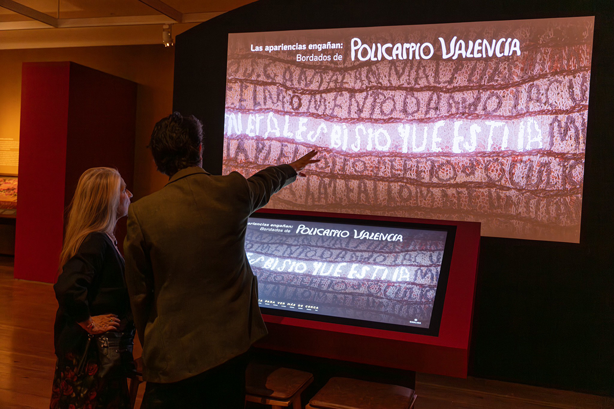 At the Museum of International Folk Art, guests engage with a digital interactive to discover the textual details of Policarpio Valencia's woven works.