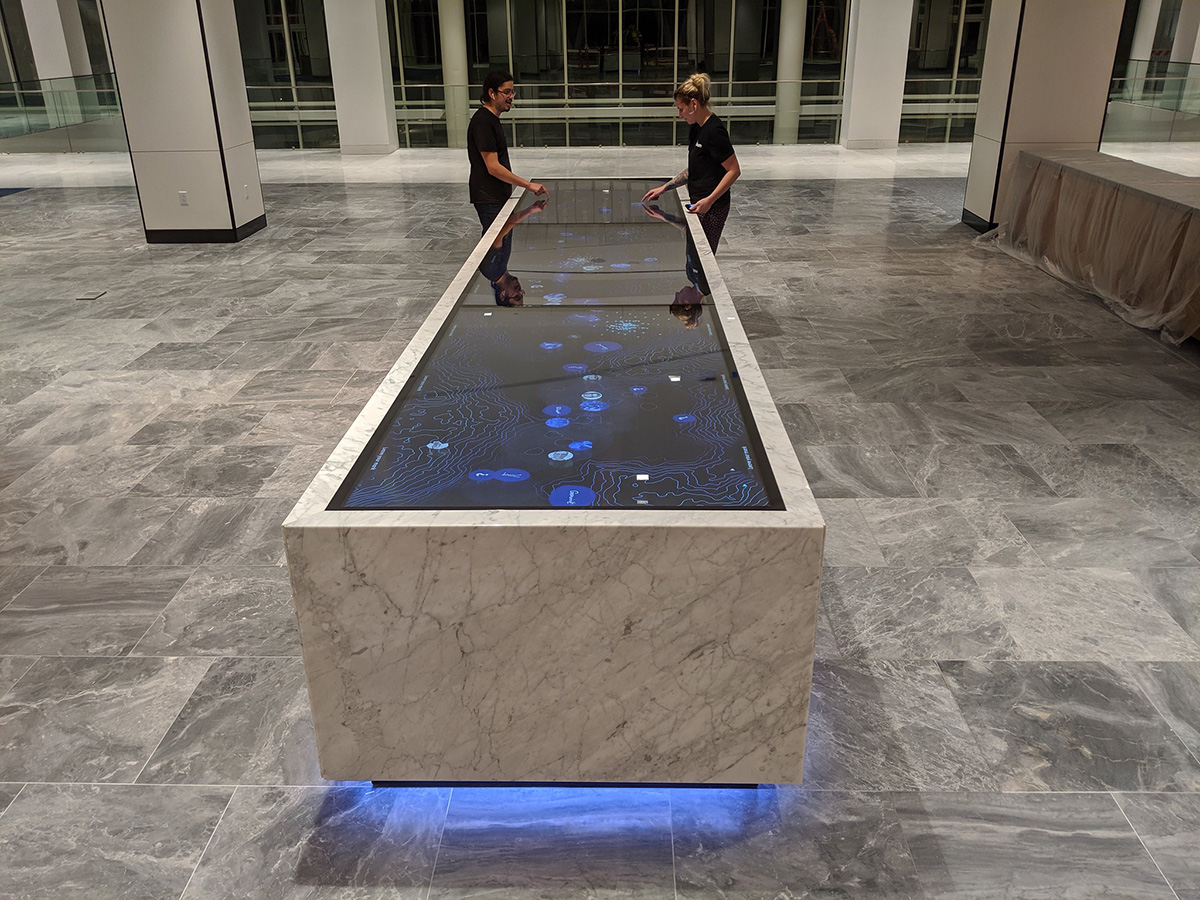 A custom marble touch table developed with IDEO and Gensler with three 86" touch displays.