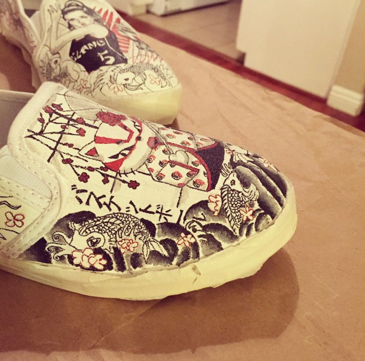 Custom painted slip on shoes in black red and white in a Japanese tattoo style and Hello Kitty in kabuki mask