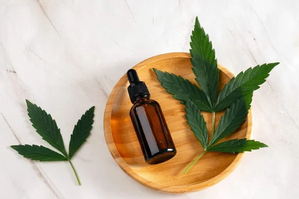 Cannabis leaves and extract bottle used for cannabis marketing