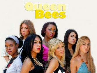 Promo still for Queen Bees. Seven young women look at the camera with serious expressions.