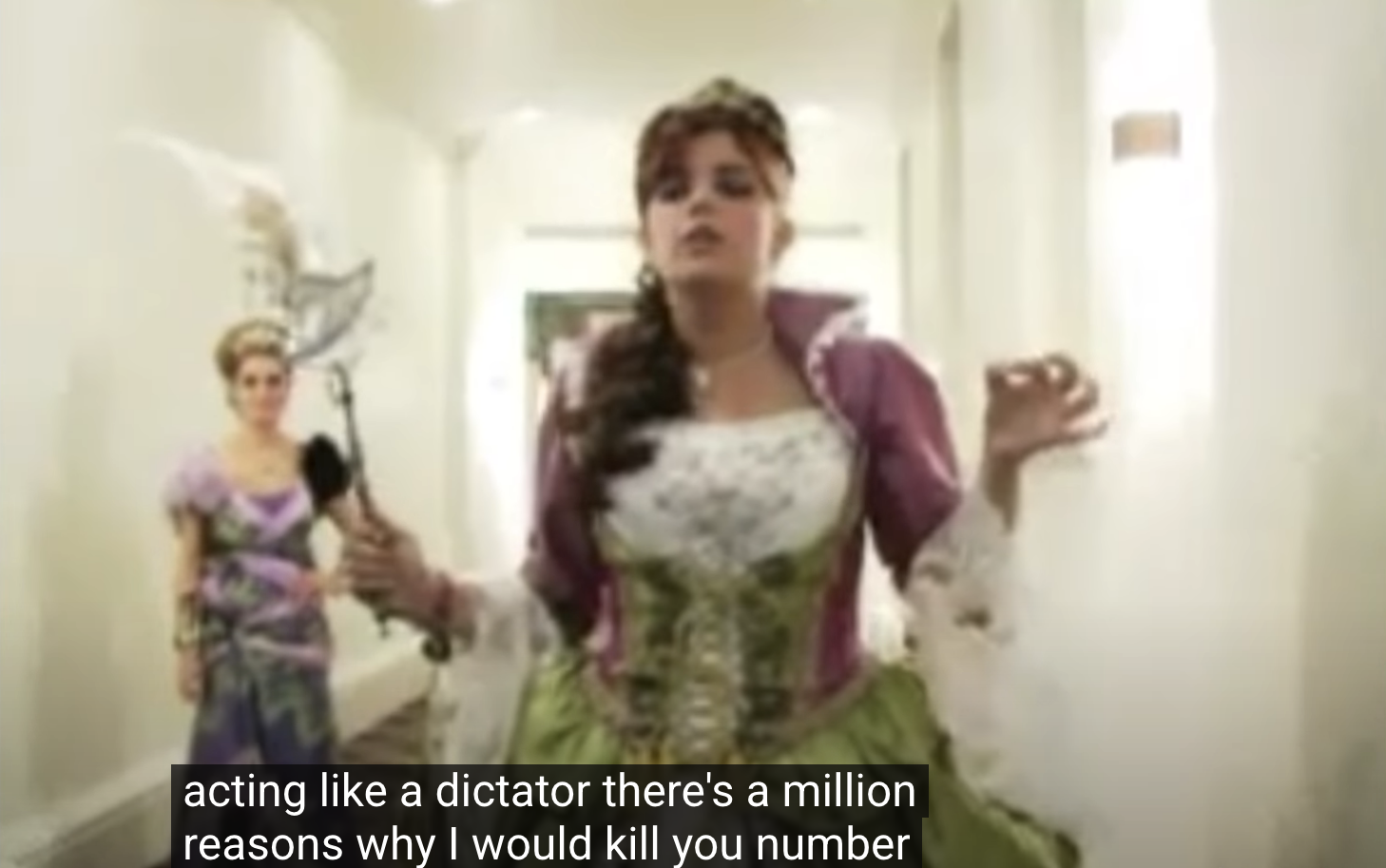 TV still from My Super Sweet 16. A teenage girl dressed like a medieval queen walks down a hallway. Closed caption textL "acting like a dictator there's a million reasons why I would kill you number"