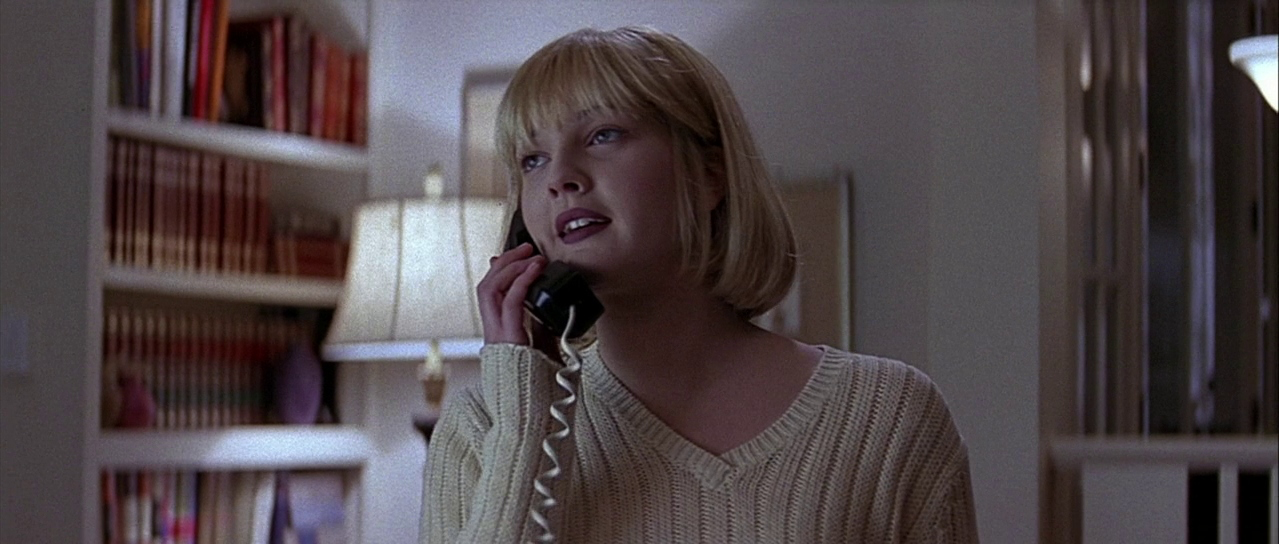 Movie still from Scream. A young woman on the phone in a nice home.