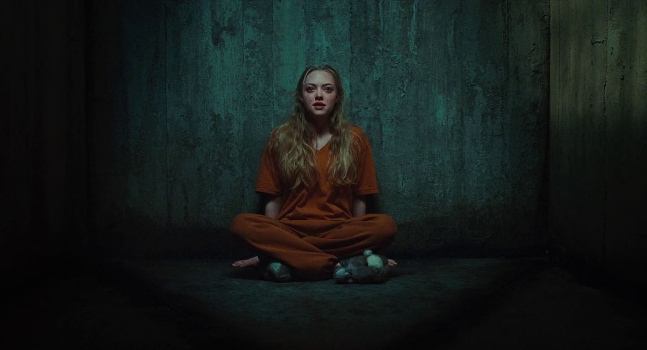 Movie still from Jennifer's Body. A teen girl sits alone in a prison cell.