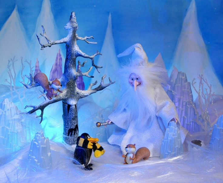 Movie still from a stop-motion movie by Rankin and Bass. A winter scene with animals and a wizard.