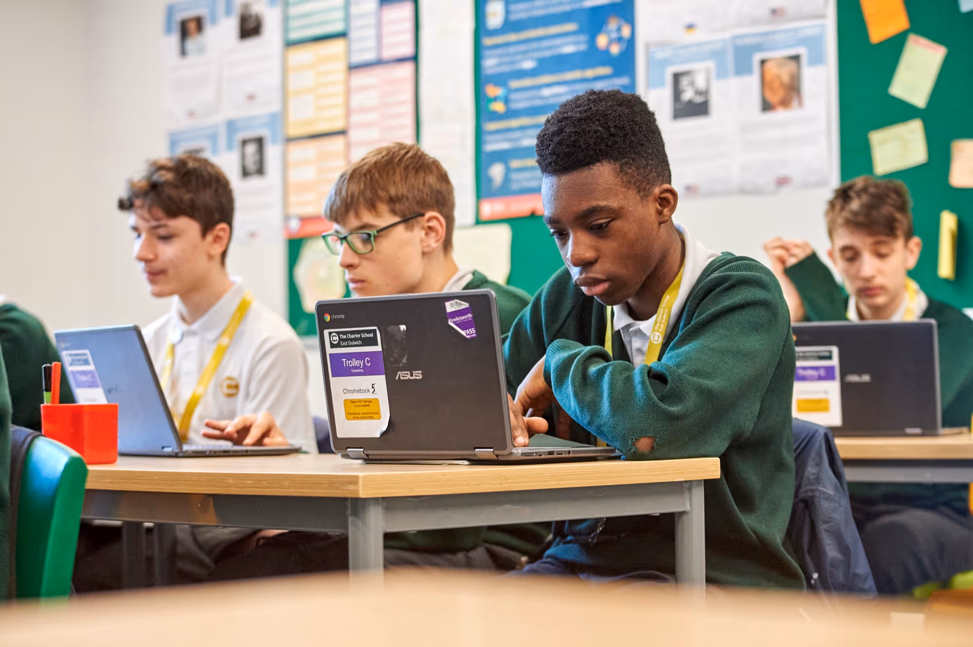 Male student working on their laptop at The Charter School East Dulwich