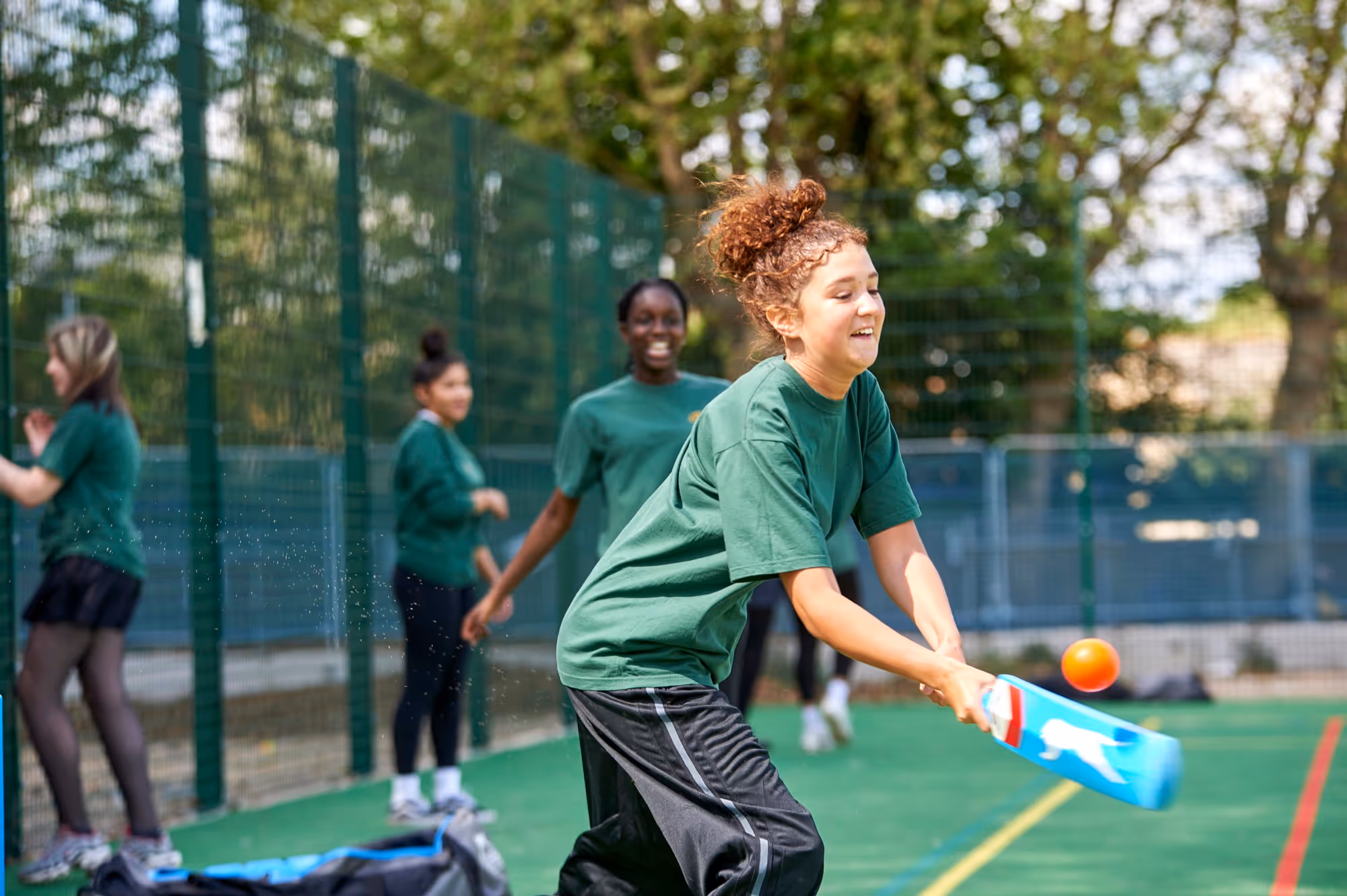 A student playing cricket at The Charter School East Dulwich