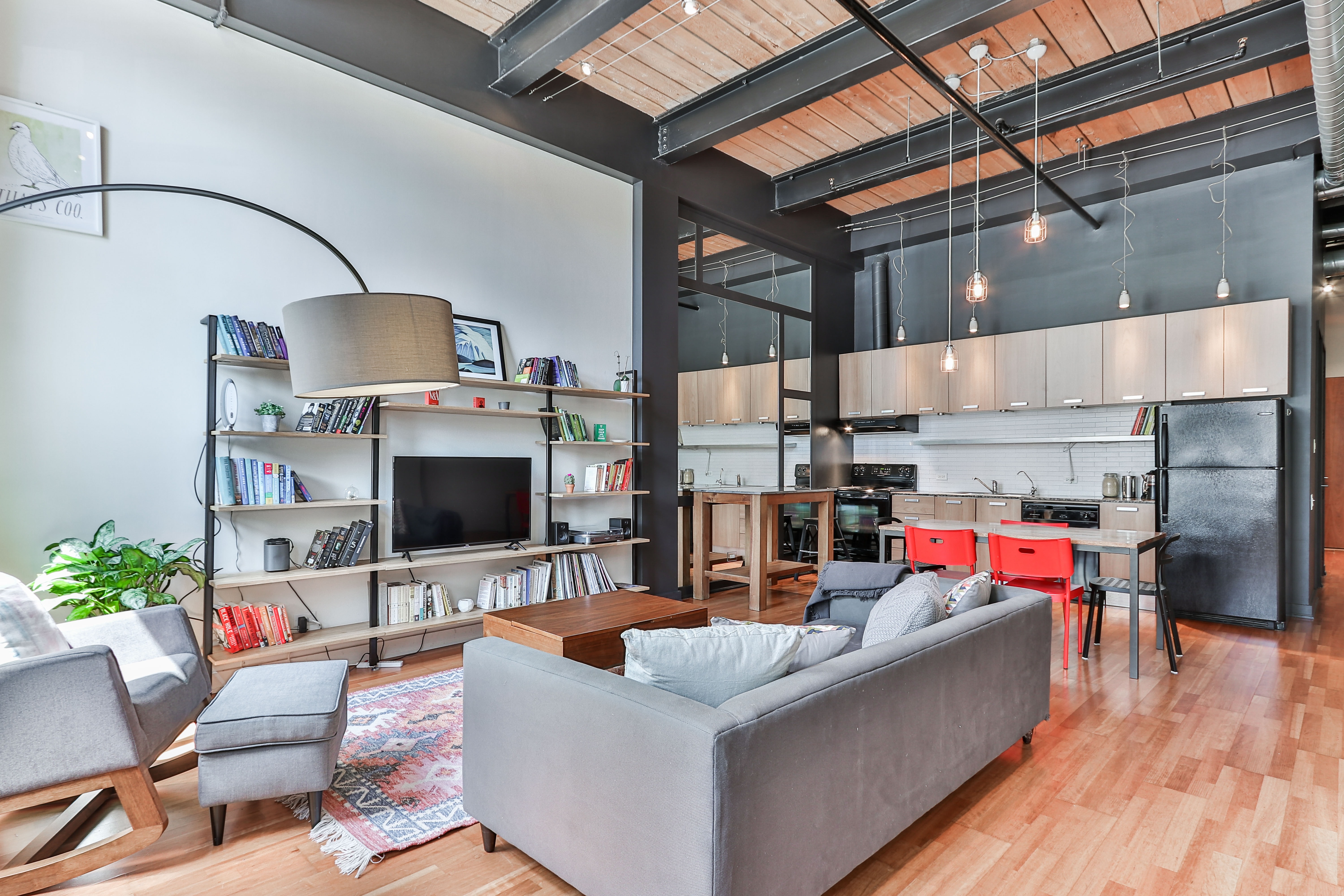 Contemporary loft with exposed beams, tall ceilings and an open kitchen