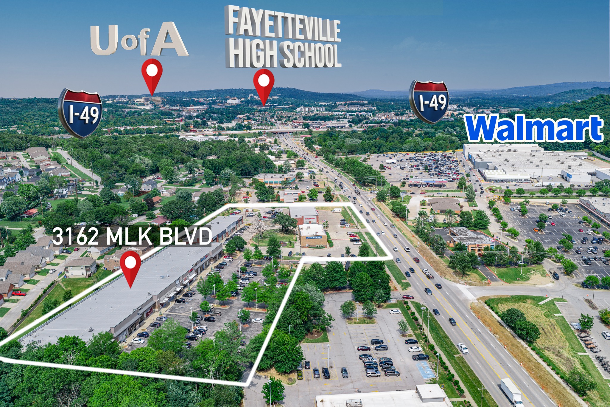 Annotated aerial view of Martin Luther King Jr Boulevard in Fayetteville showing nearby schools, shopping and Interstate 49