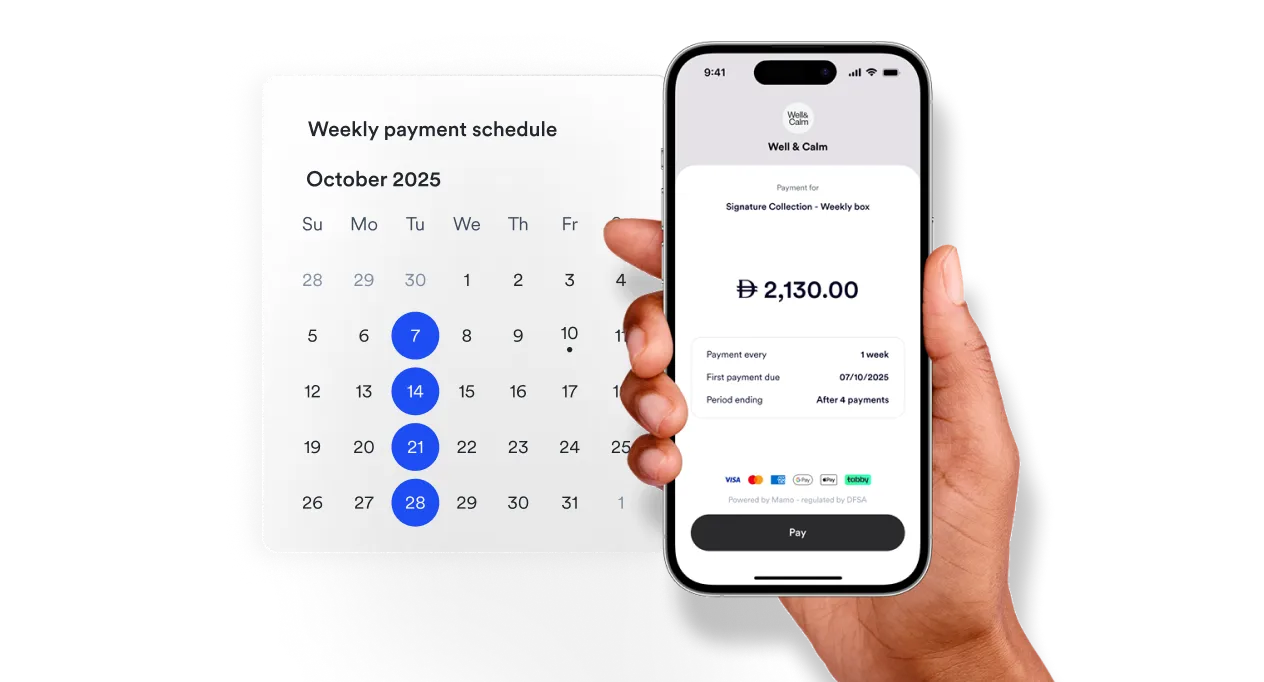 A person holding a smart phone in front of a calendar.