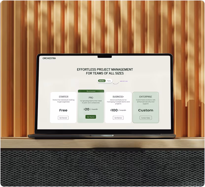 Laptop displaying pricing plans for project management software with Starter, Pro, Business+, and Enterprise options.