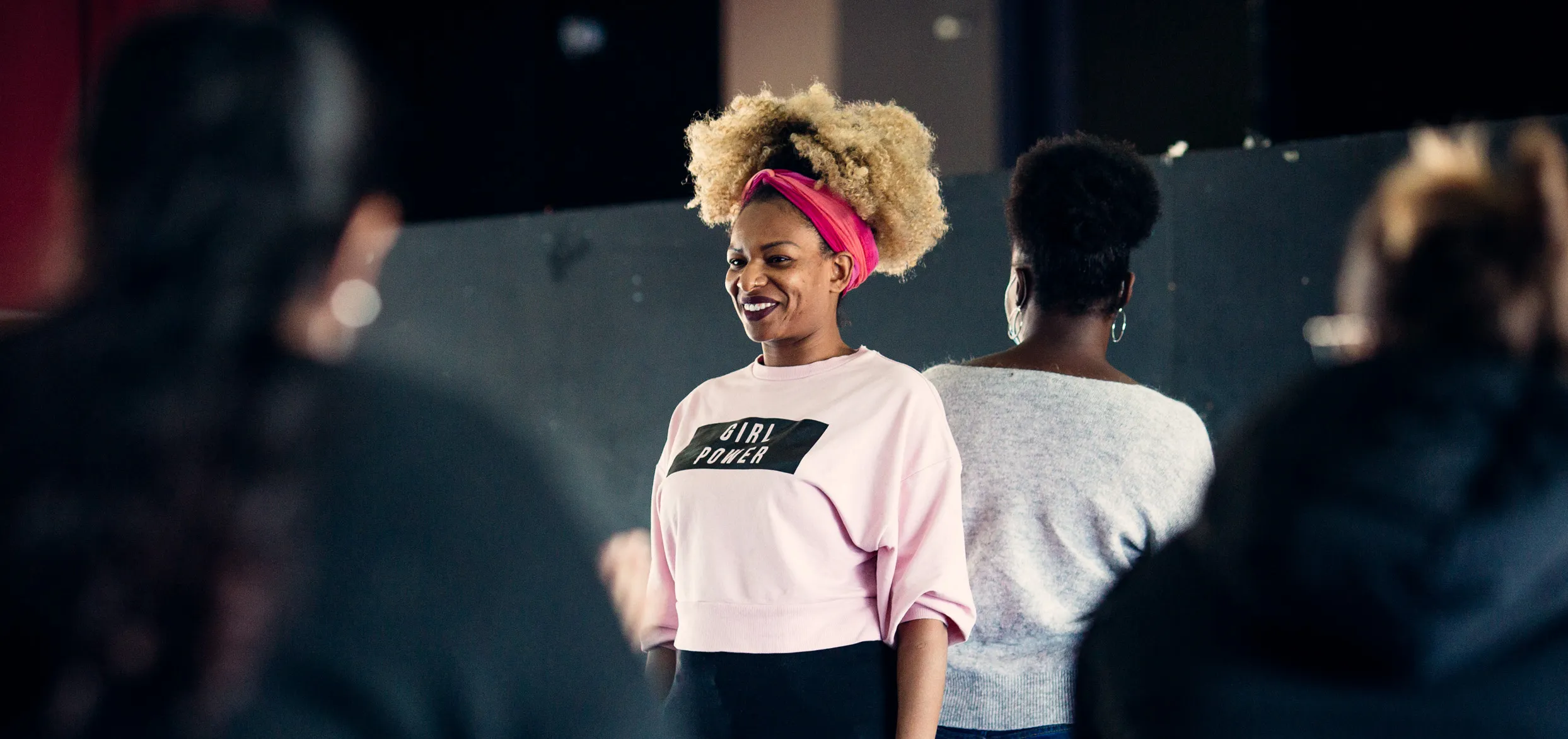 femme parlant en public et souriant à l'auditoire