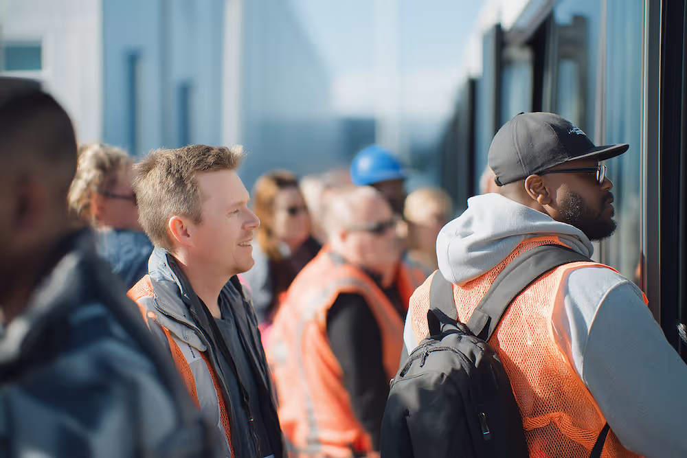 workers waiting to board the shuttle