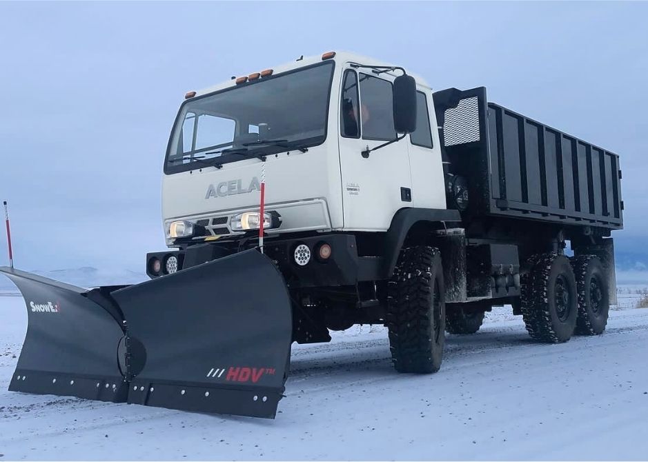 Acela Monterra 6x6 equipped with dump body and front-mounted plow for heavy-duty utility and snow removal operations