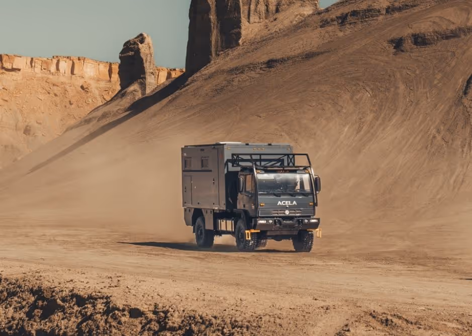 Acela Monterra 4x4 built by KRUG Expedition driving through desert terrain on an overland adventure