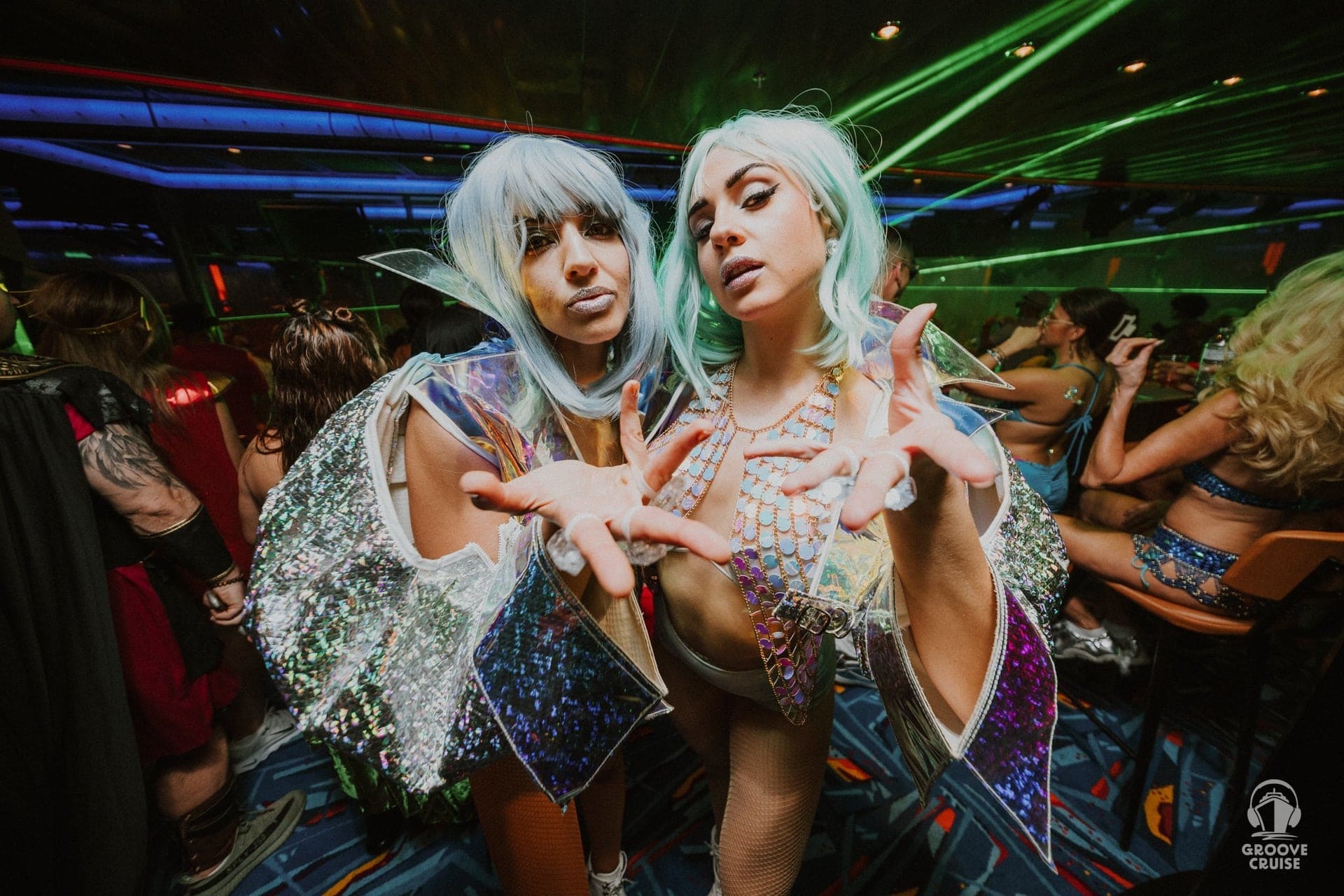 EDM fans partying under lasers on cruise ship stage at night