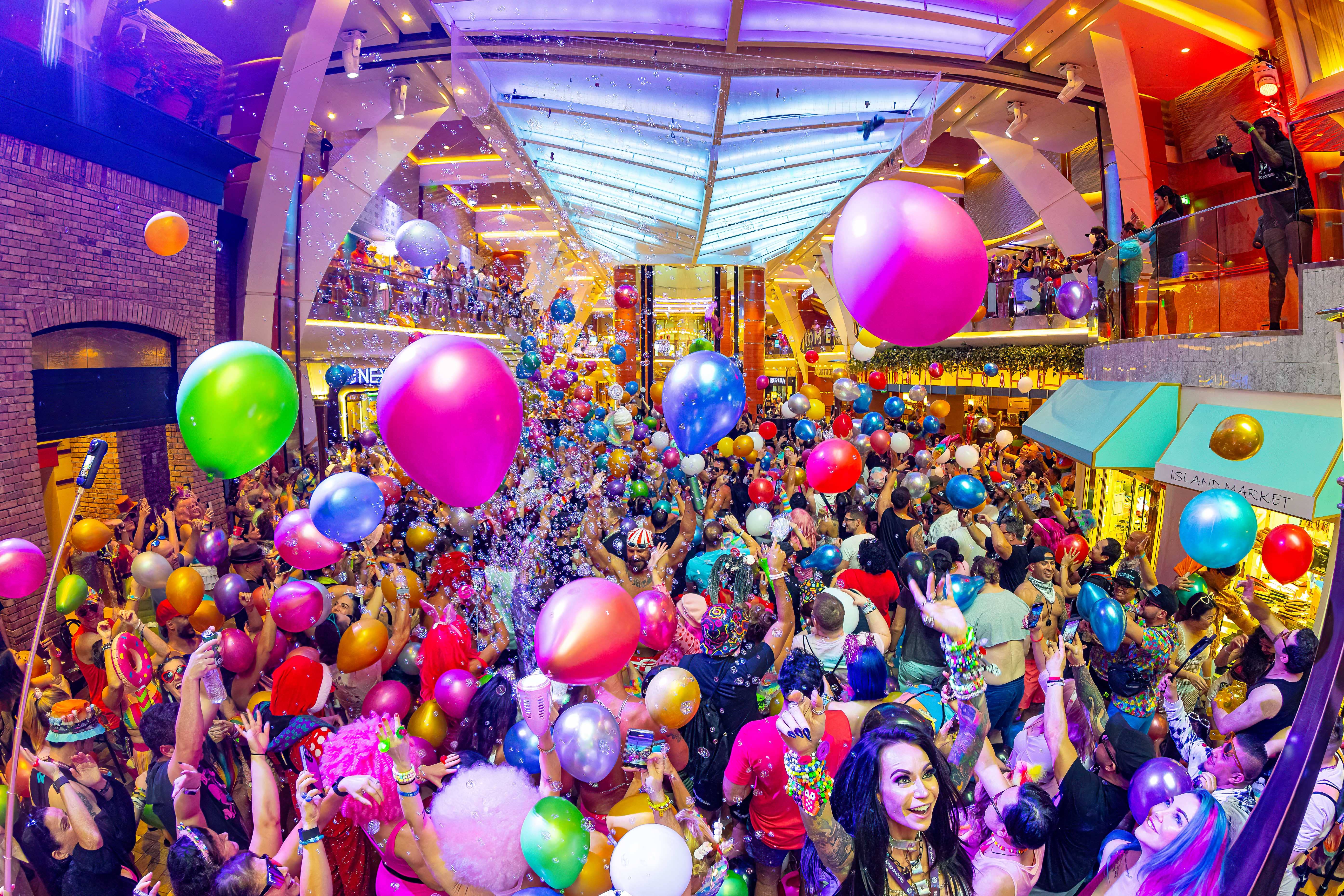 Festival cruise DJ stage with balloons and dancing crowd