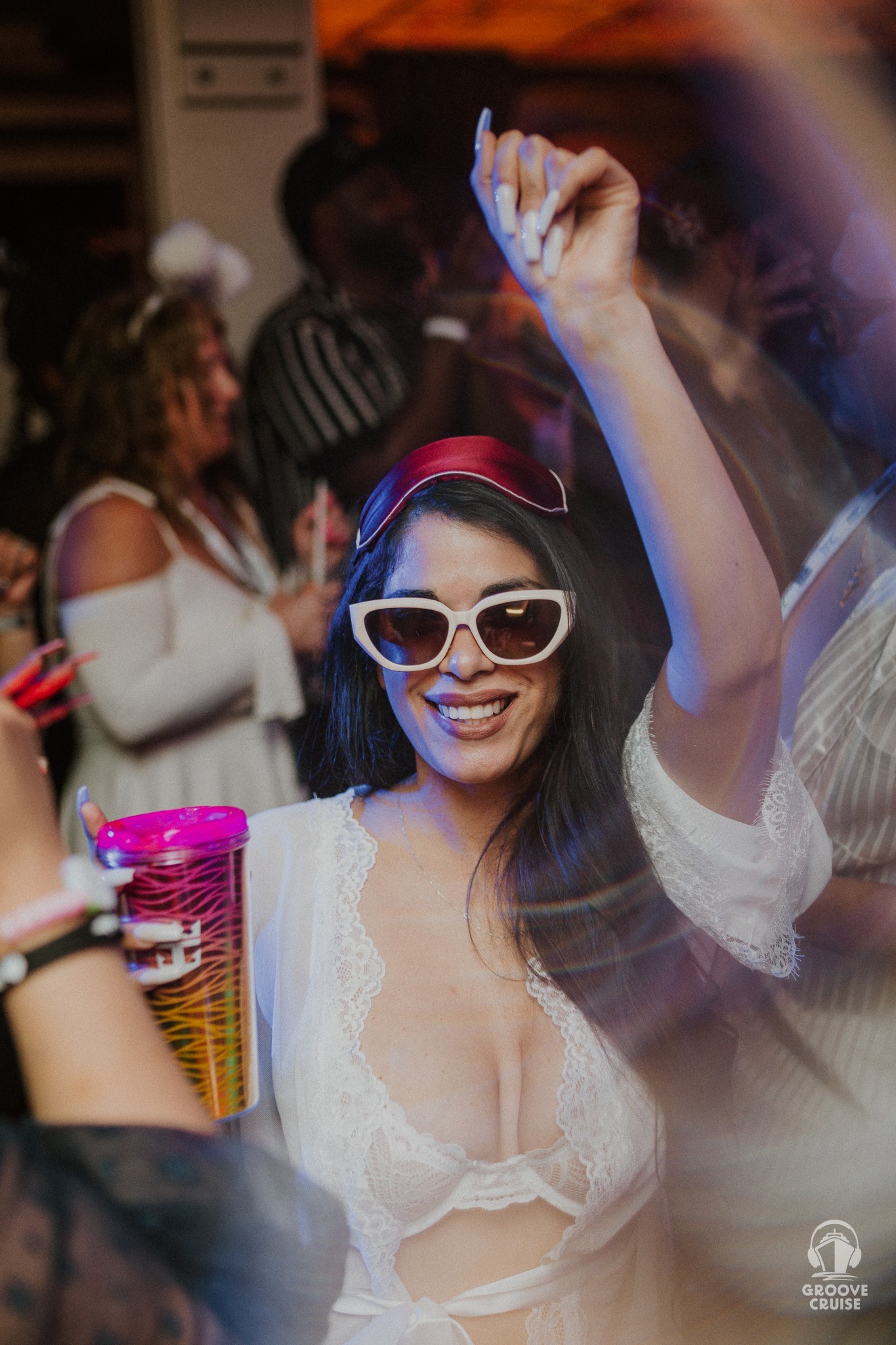 Solo traveler dancing on Groove Cruise during nighttime rave
