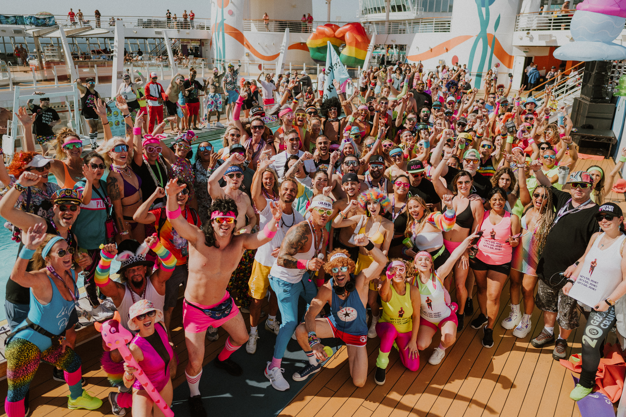 Groove Cruise 2025 guests dancing on the ship deck during EDM cruise festival