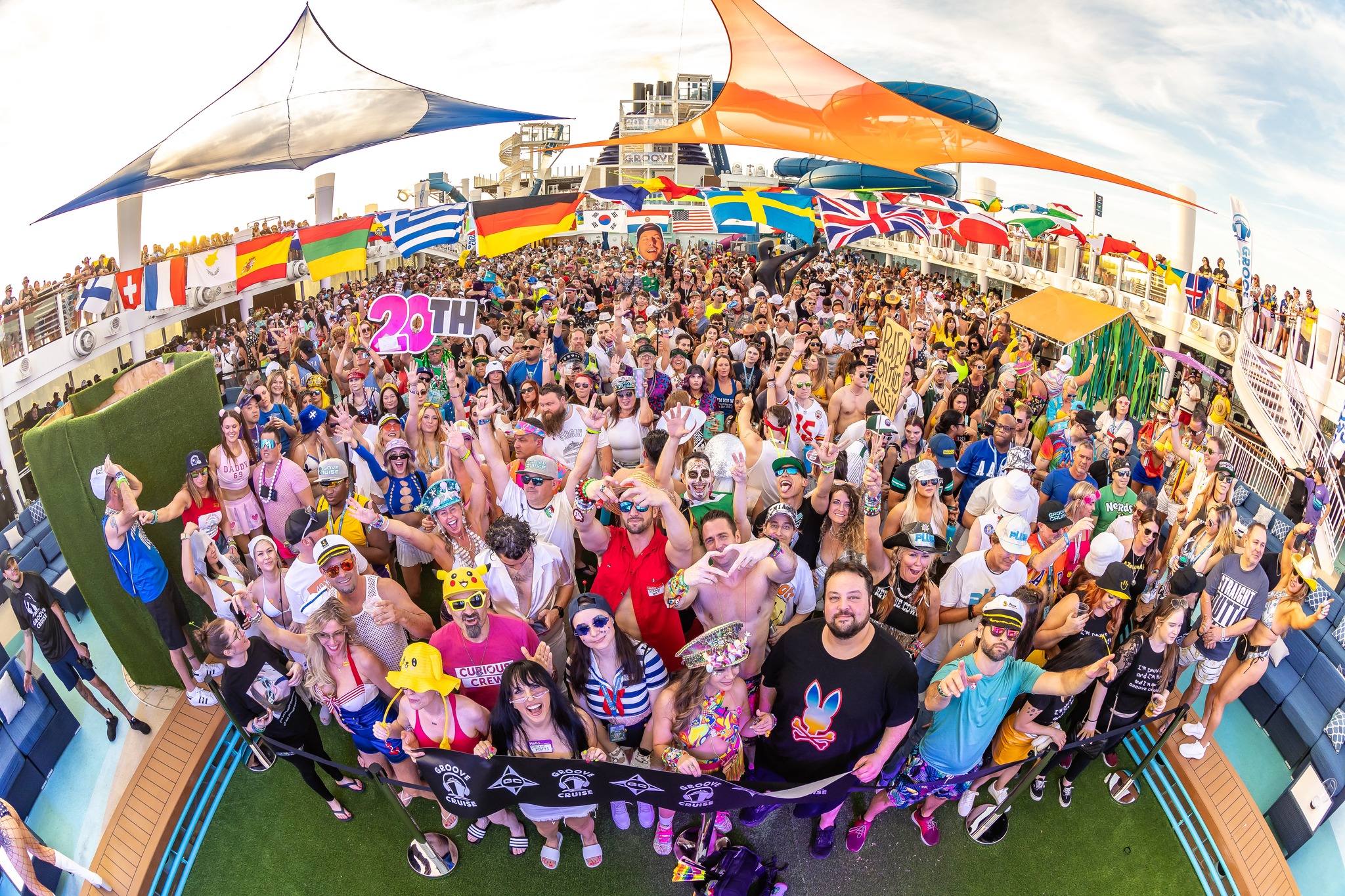 International Groove Cruise attendees waving flags and sharing culture at sea