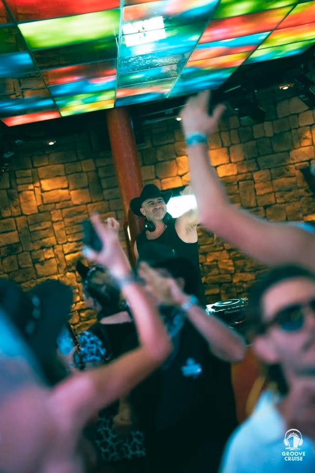 Festival attendees dressed in themed outfits at the YEEDM party on Groove Cruise