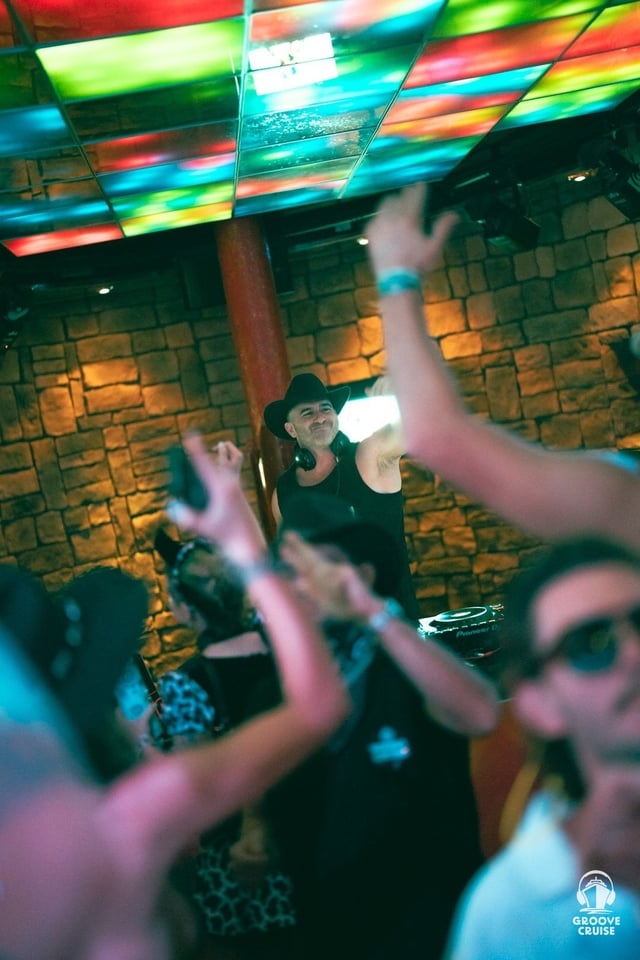 Festival attendees dressed in themed outfits at the YEEDM party on Groove Cruise