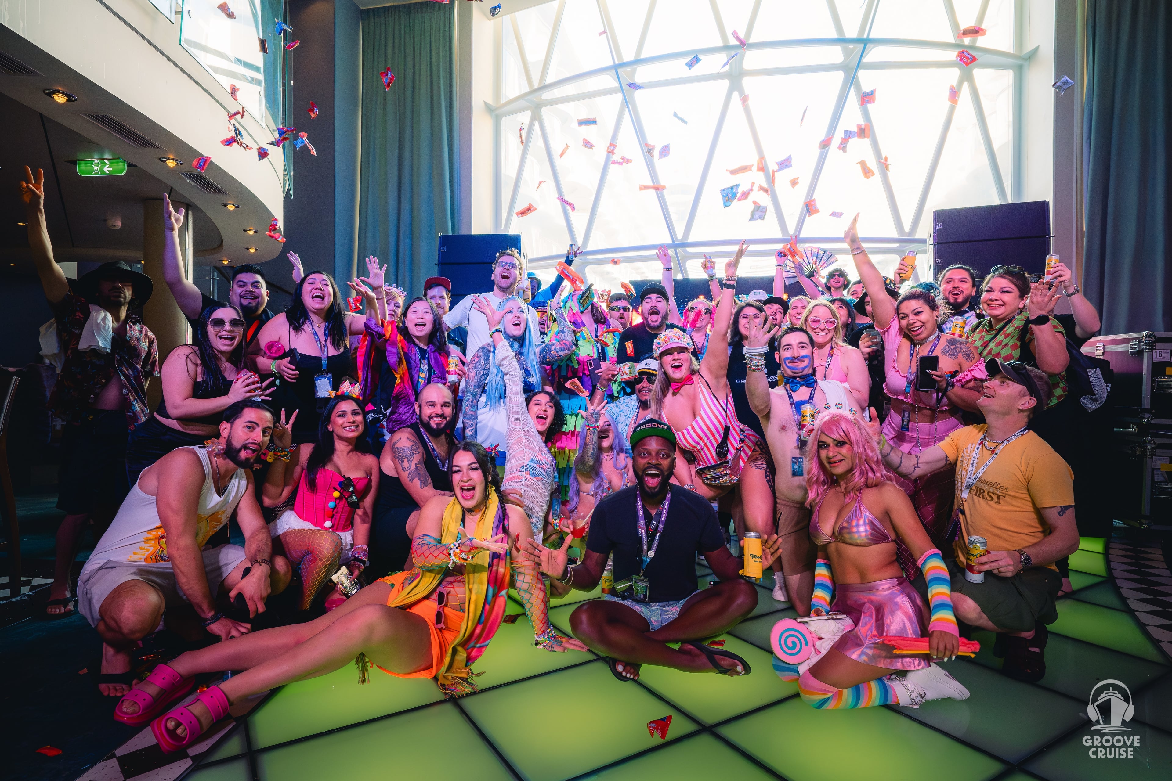 Festival cruise guests at meetup on Groove Cruise dancing and smiling together